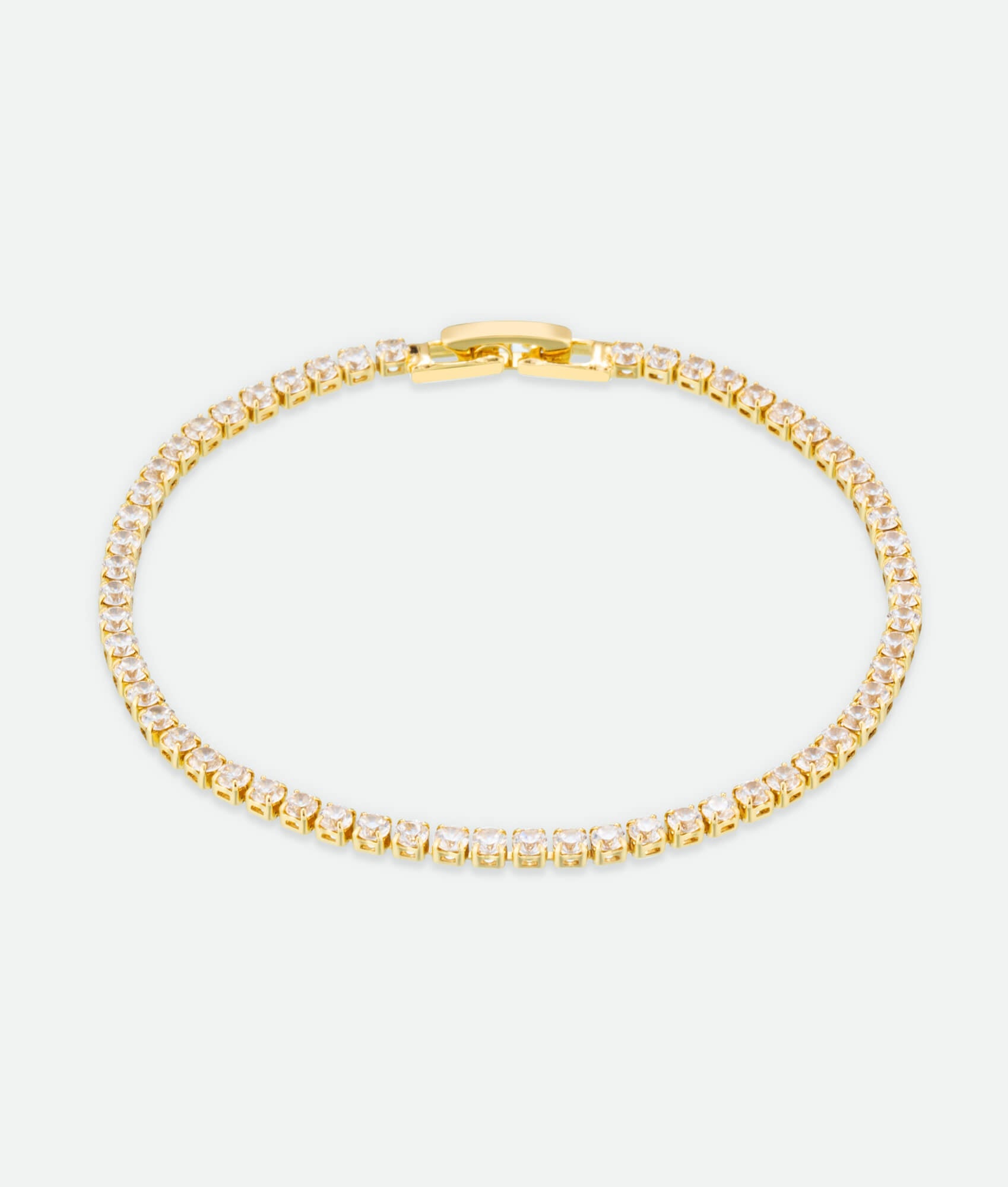 Gold bracelet with clear stones on a white background