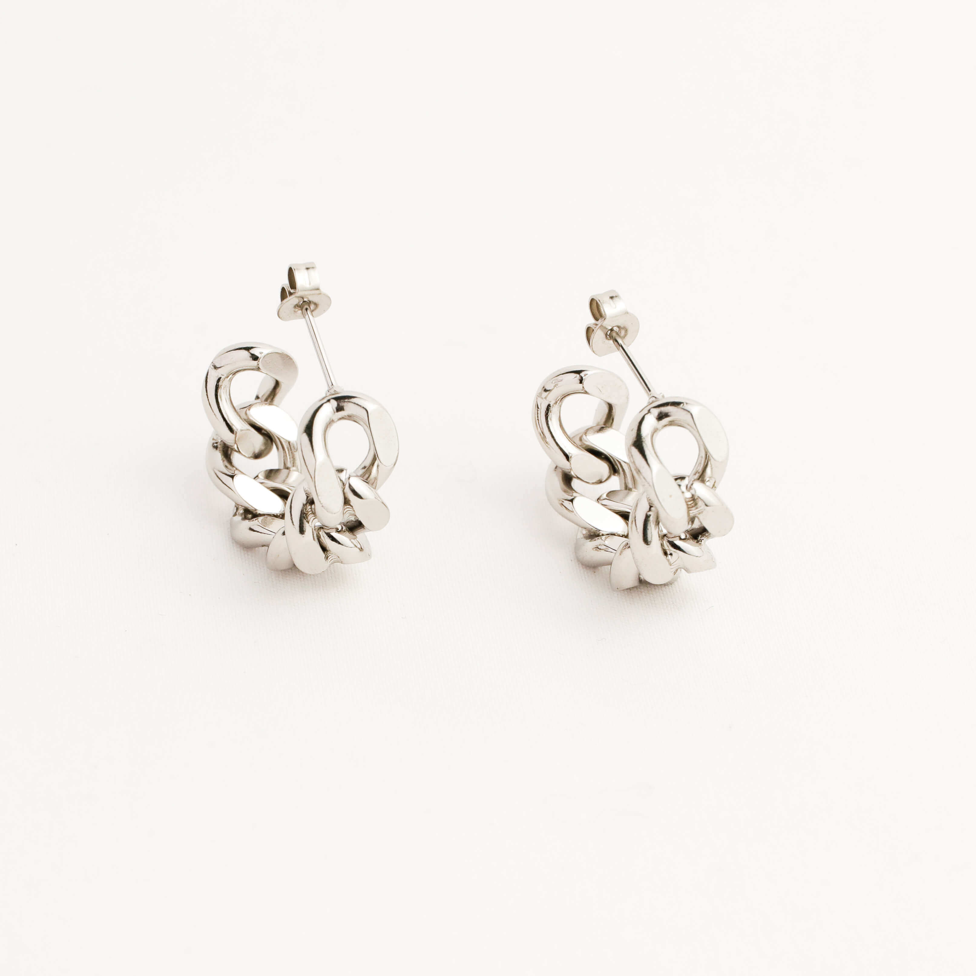 Pair of silver earrings on a white background