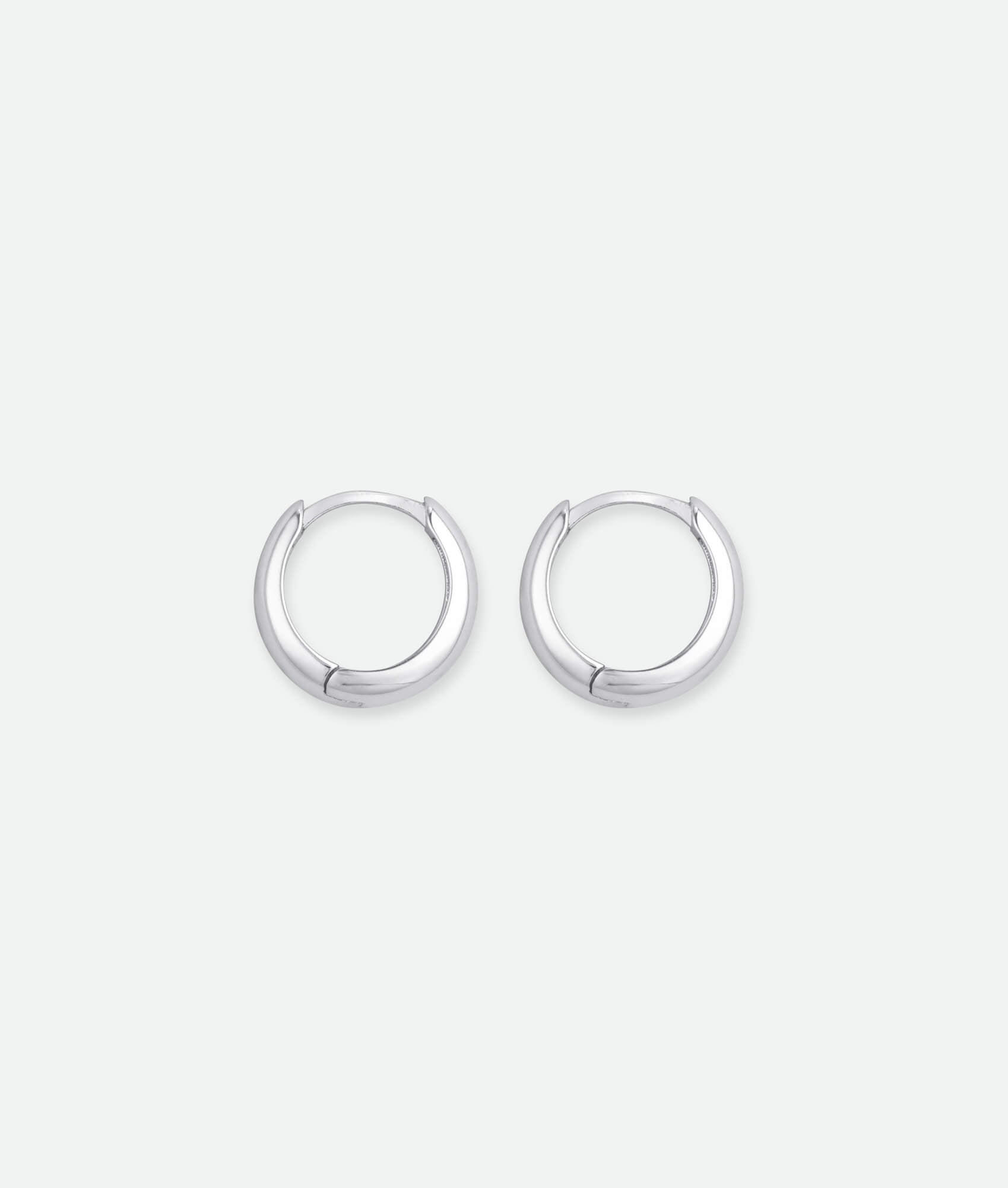 Pair of silver hoop earrings on a white background