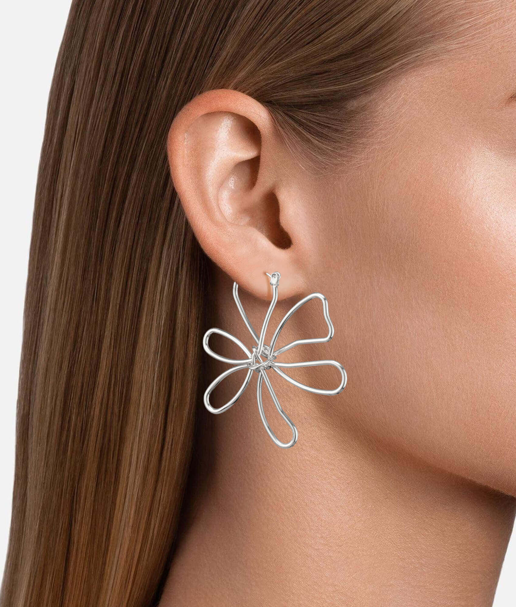 model wearing 18k silver flower earrings