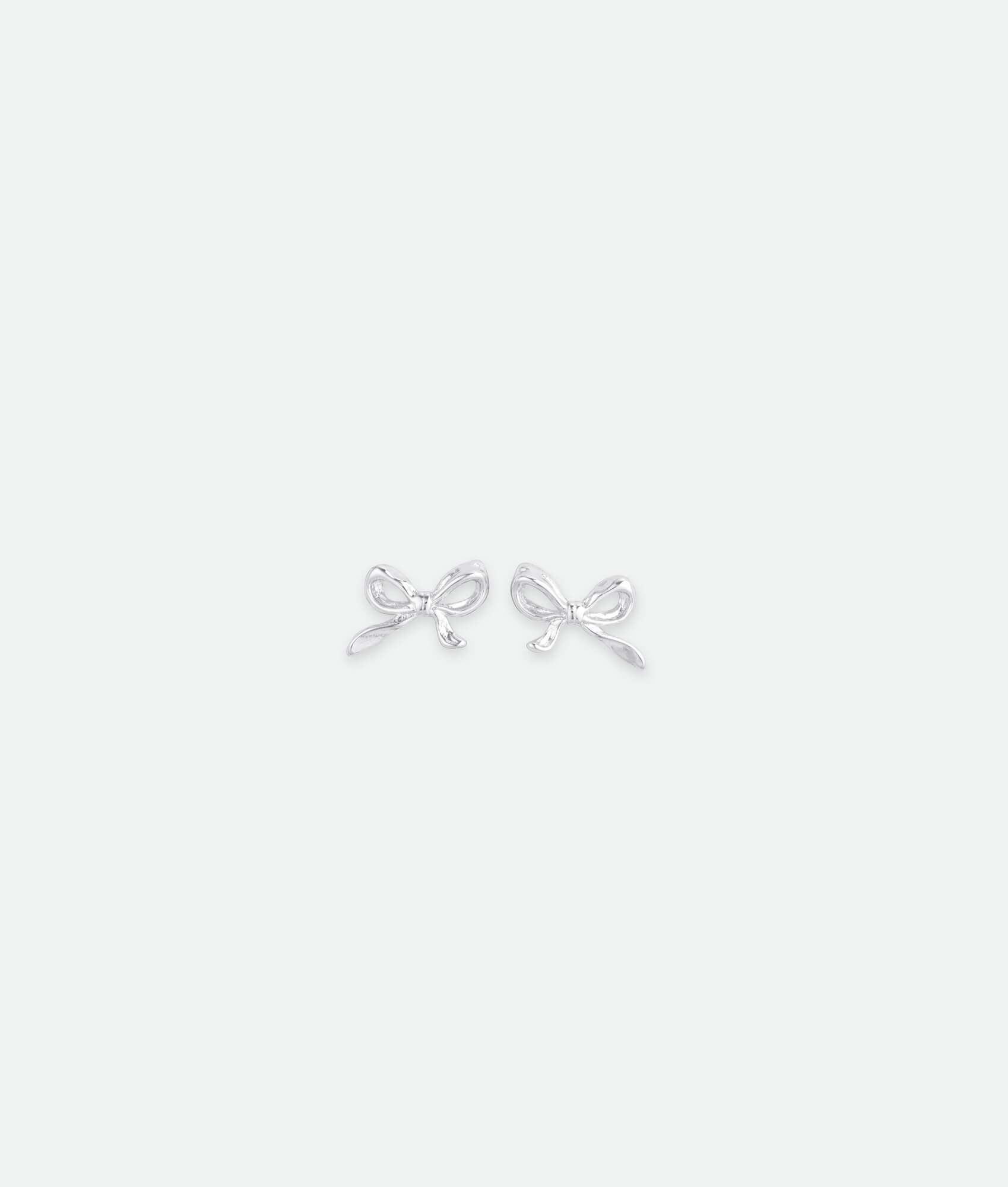 Silver bow-shaped earrings on a white background