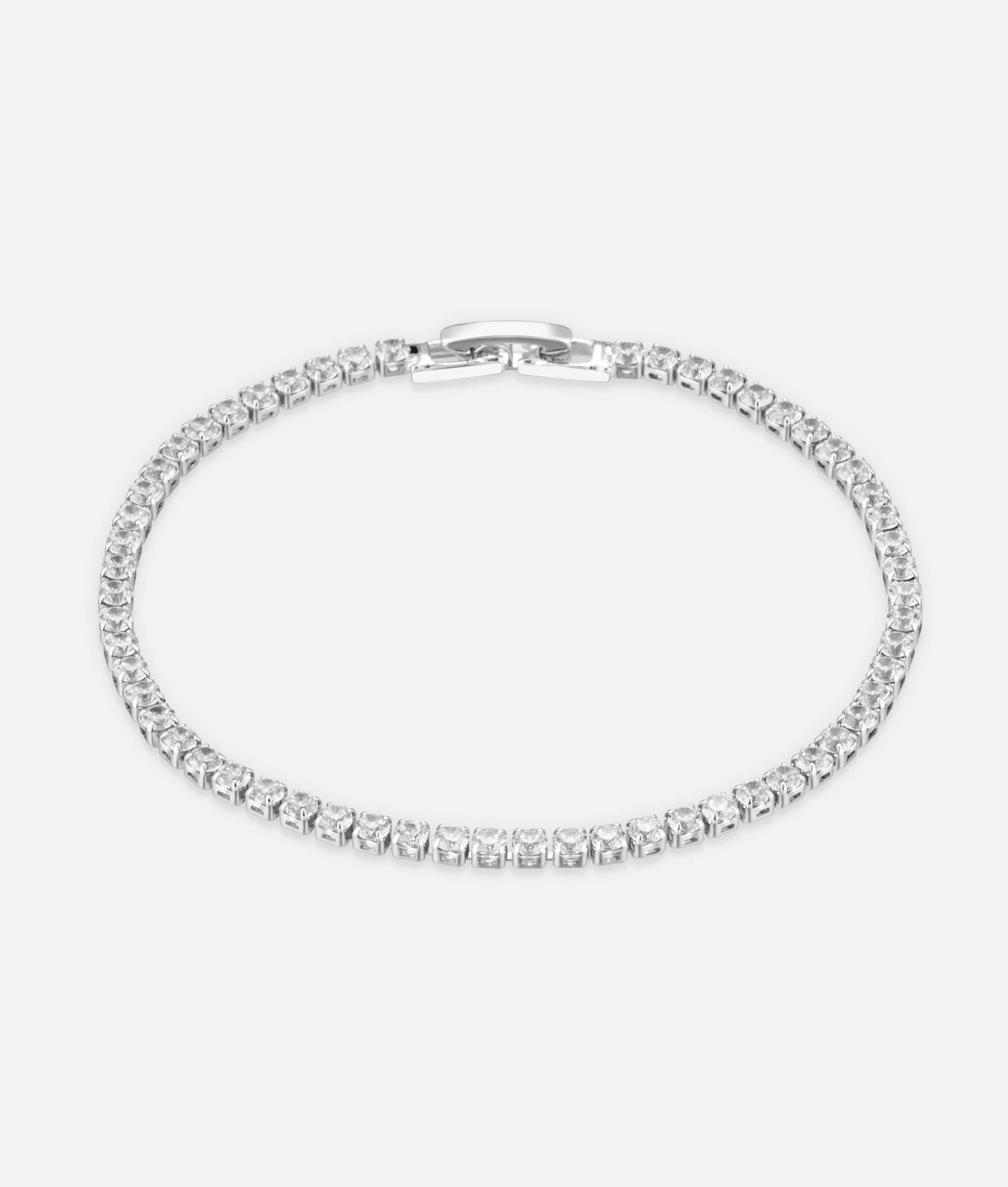 Silver bracelet with clear stones on a white background