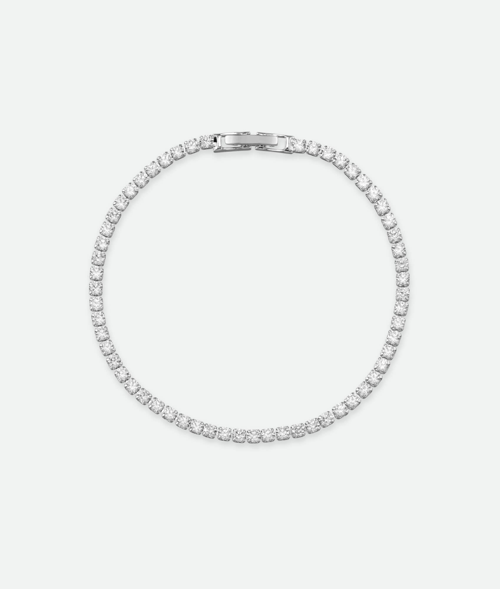 Silver bracelet with clear stones on a white background