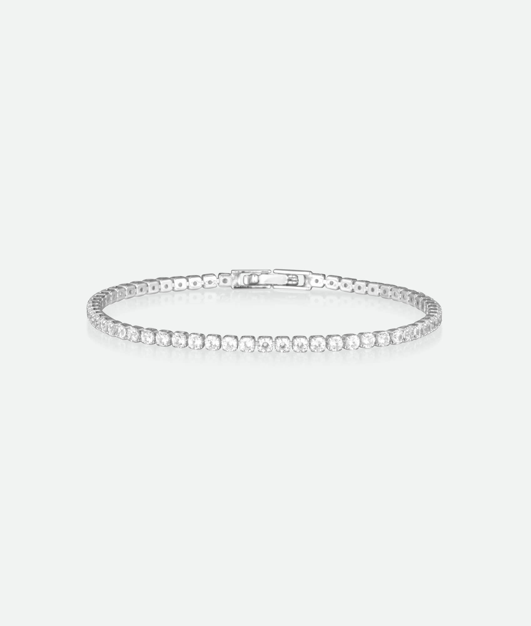 Silver bracelet with small stones on a light gray background