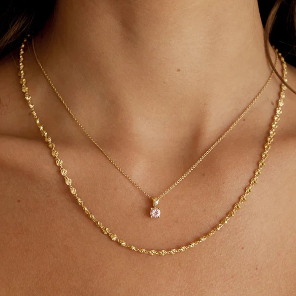 Model wearing gold beaded chain necklace