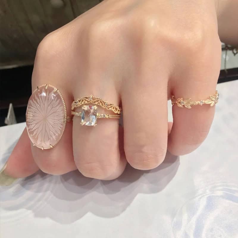 A hand with multiple gemstones rings
