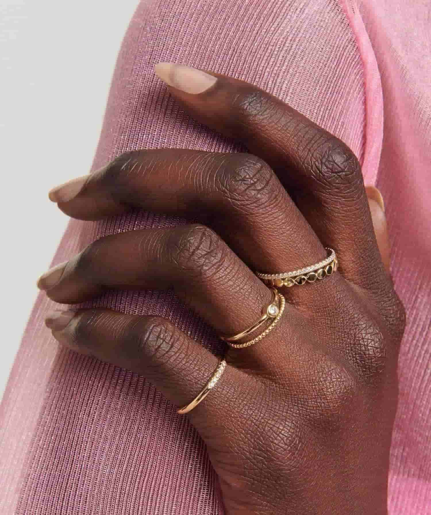 Model wearing gold rings