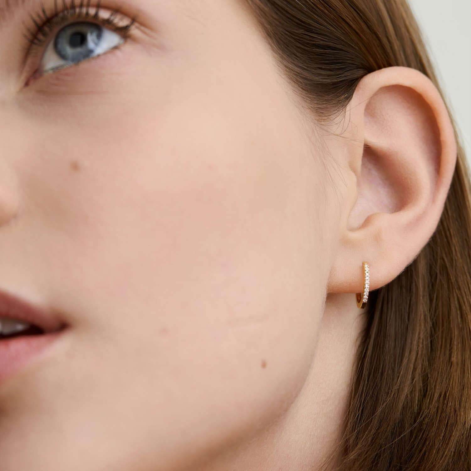 Model wearing Gold Diamond Huggie Hoop Earrings