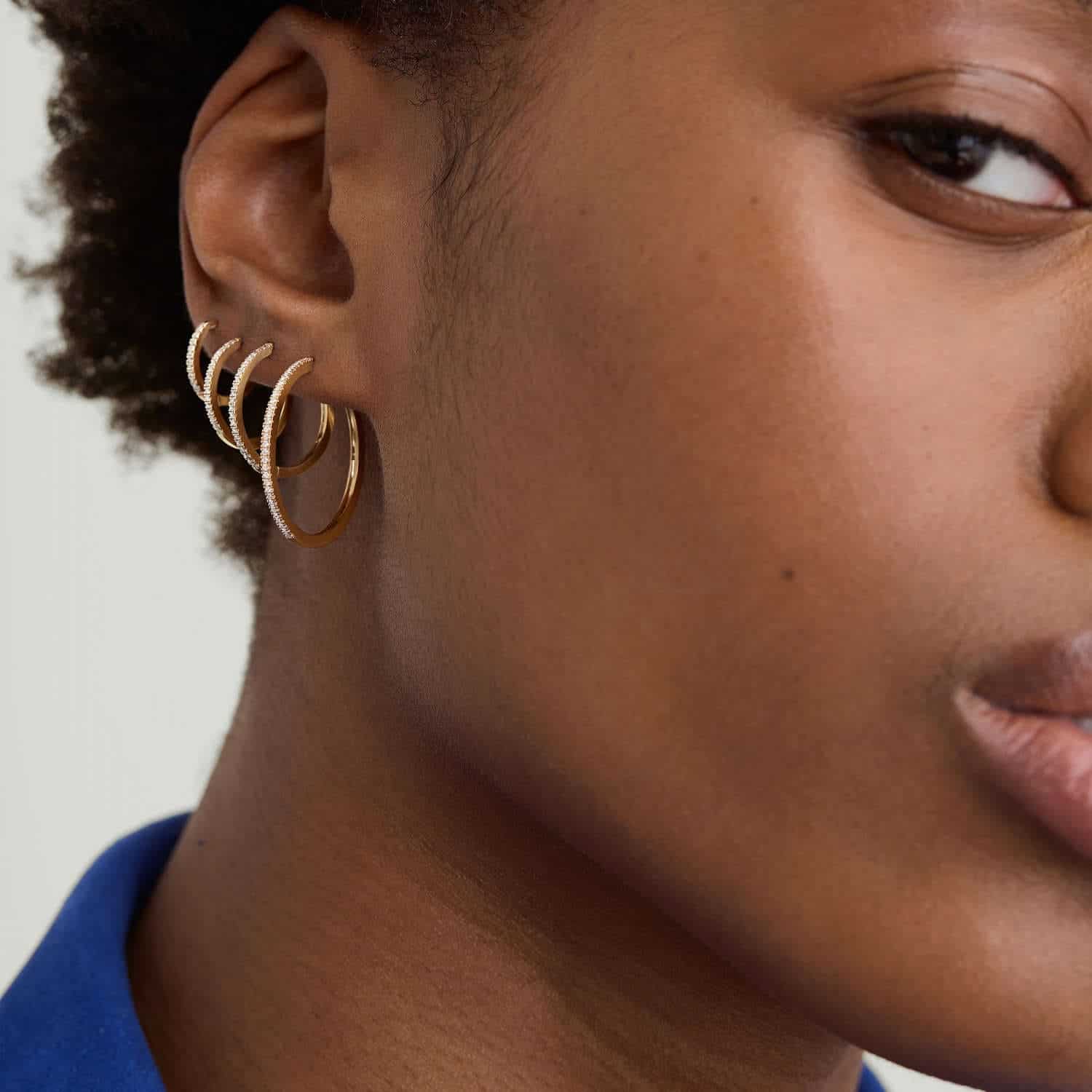 Model wearing Gold Diamond Huggie Hoop Earrings