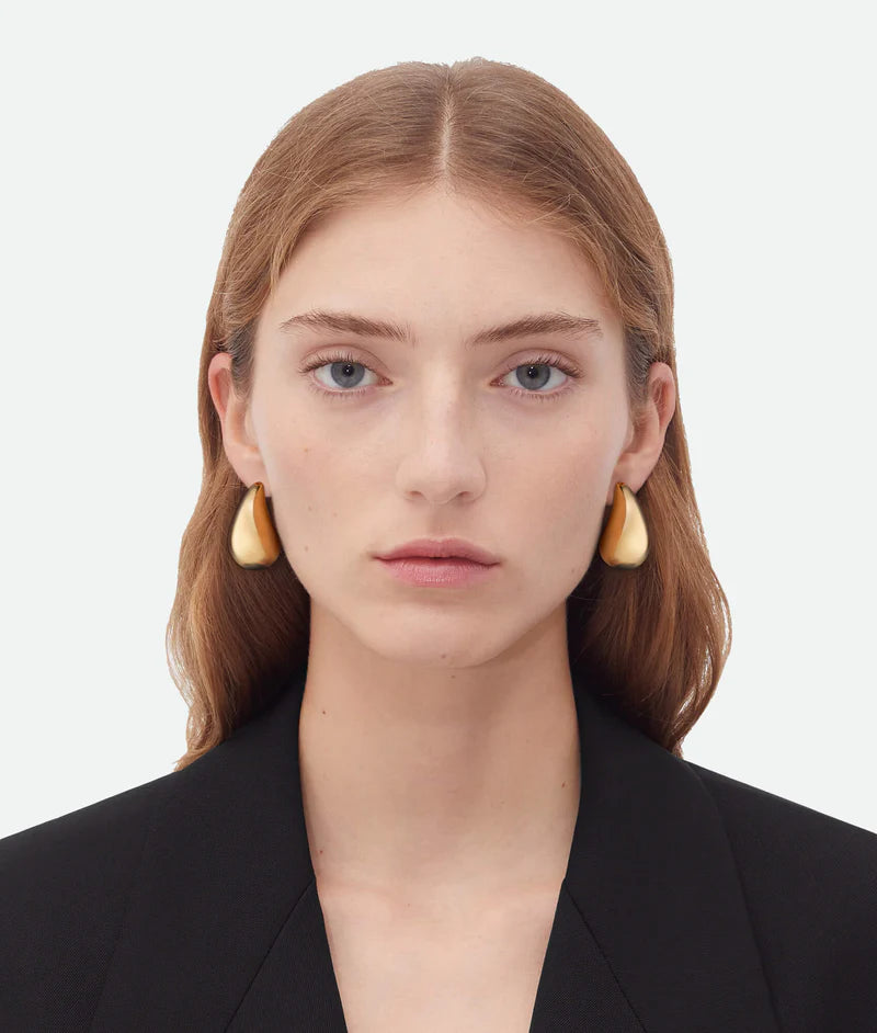 A Woman model wearing 18k Gold Drop Earrings