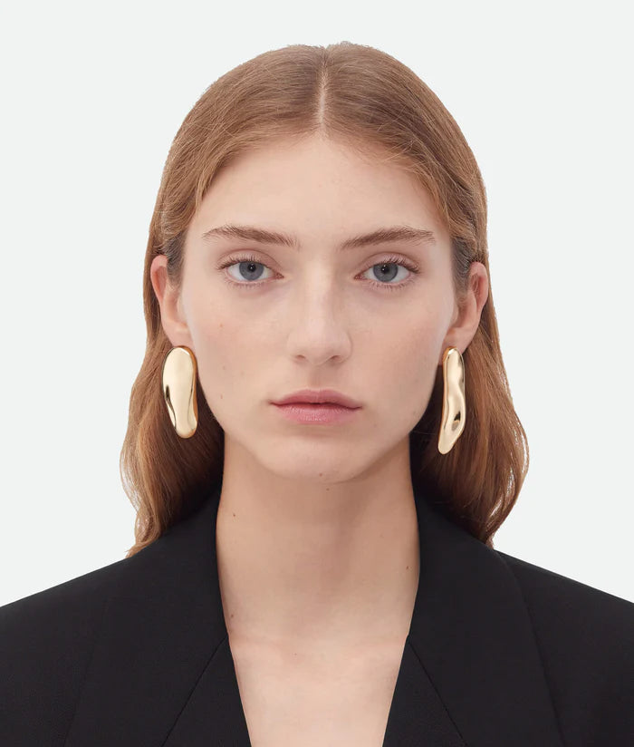 A Woman model wearing gold earrings