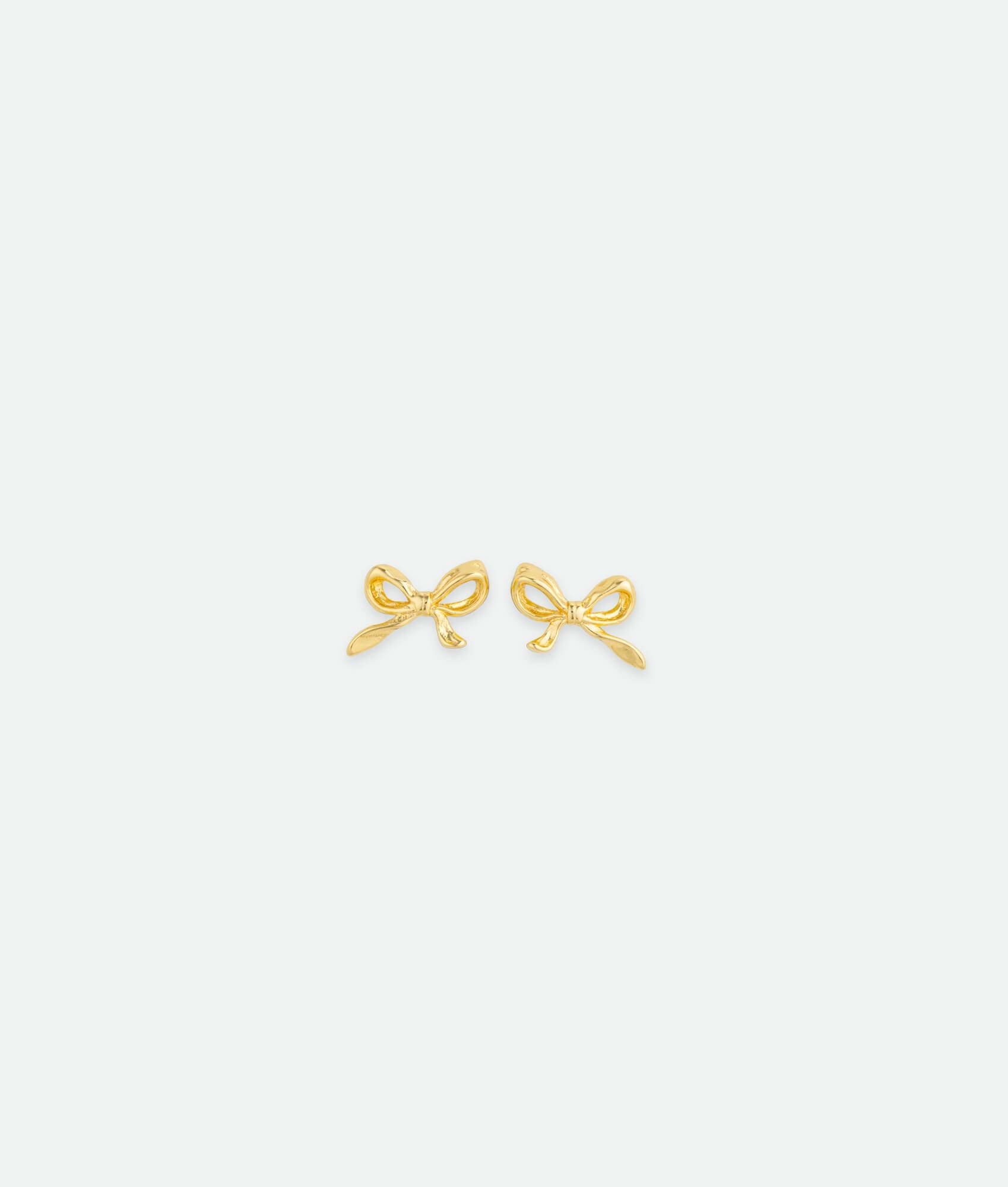 Gold bow-shaped earrings on a white background