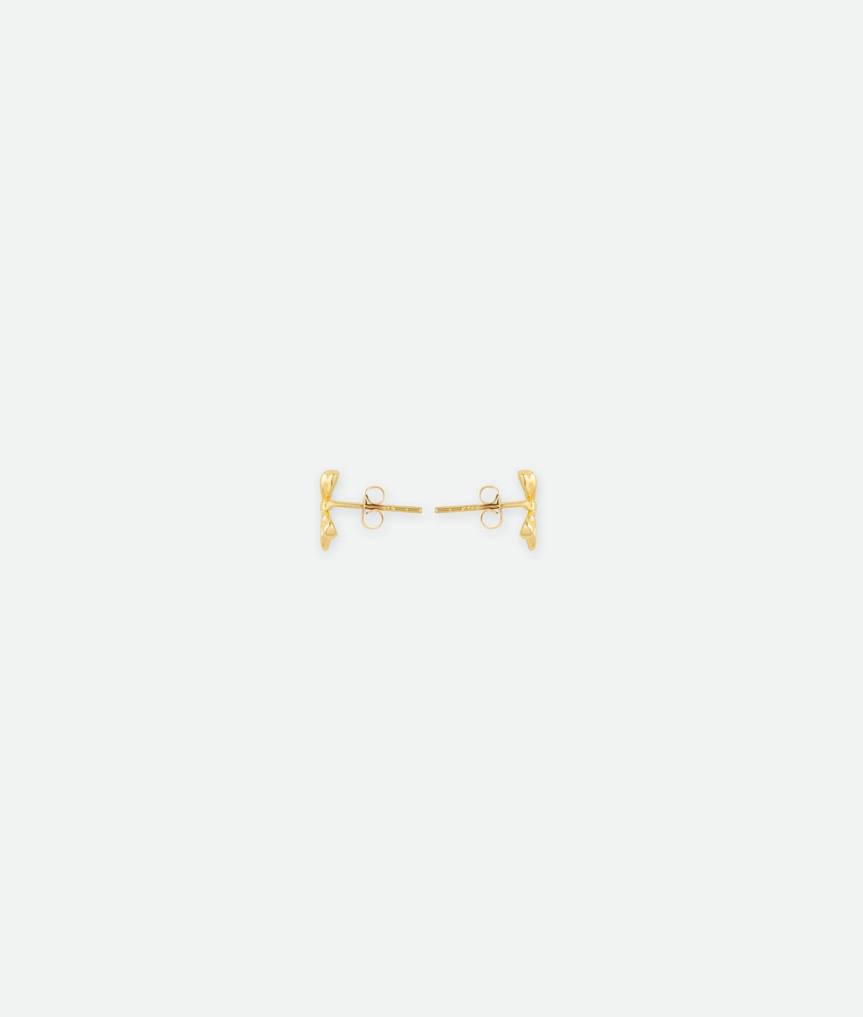 Gold earring on a white background