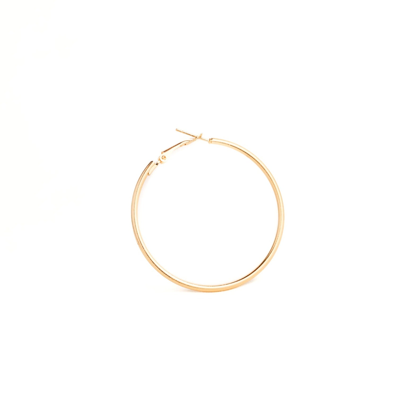 Gold hoop earring on a white background