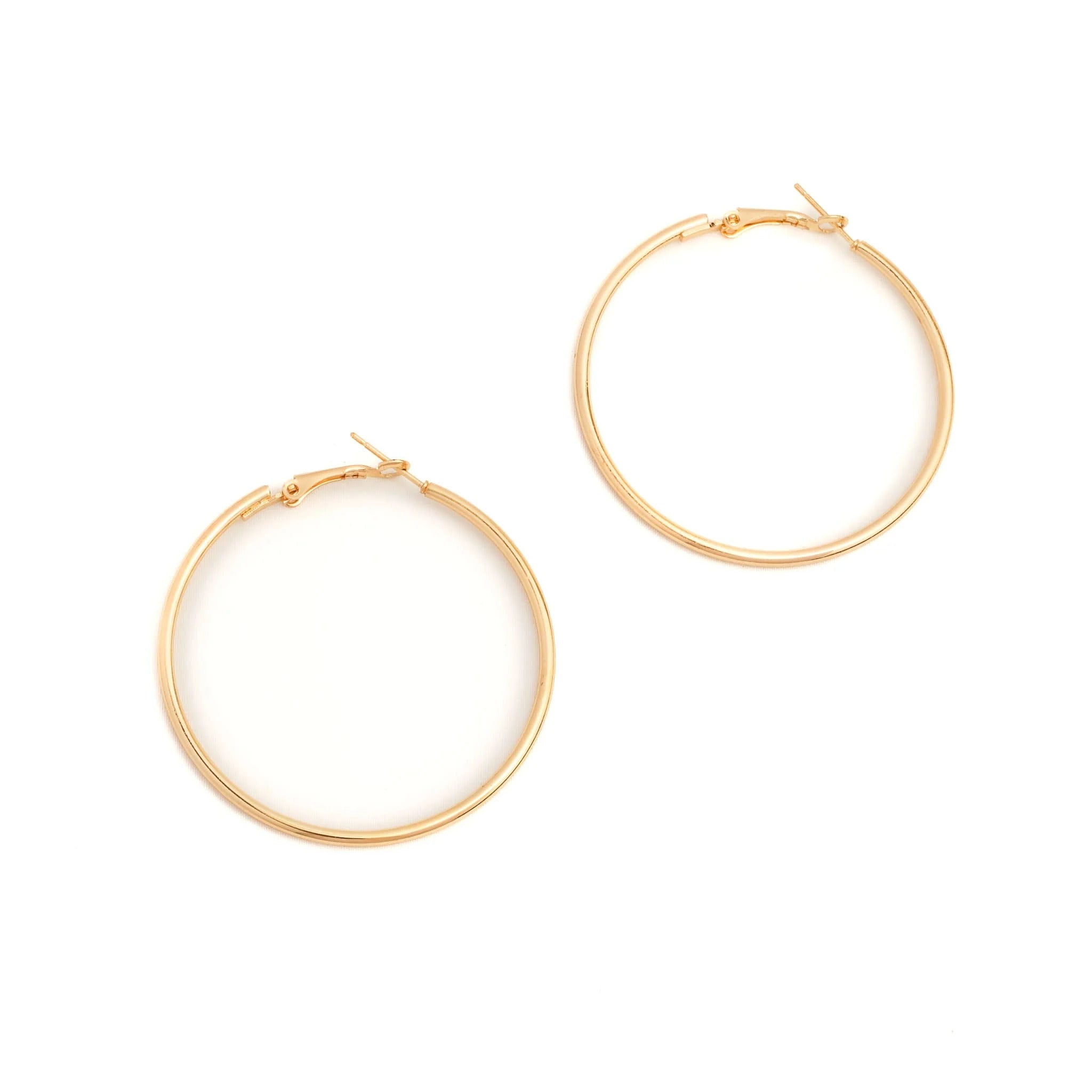 Gold hoop earrings on a white background