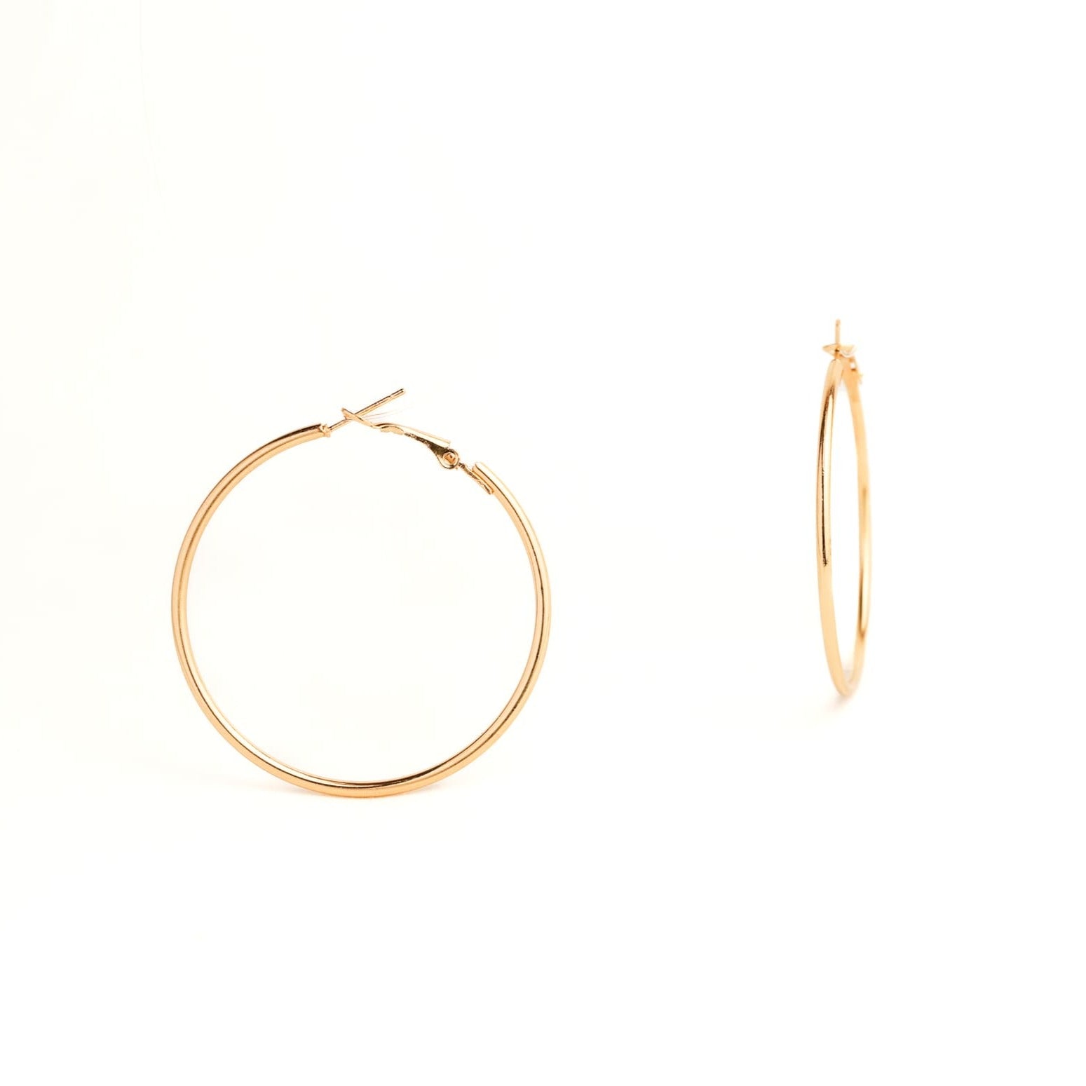 Gold hoop earrings on a white background