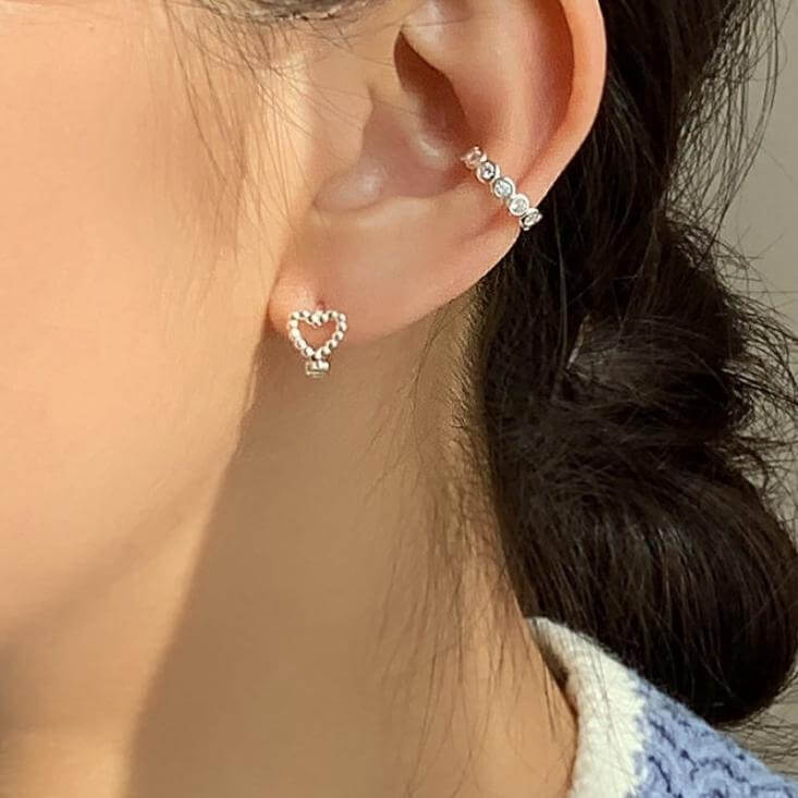Model wearing Beaded Heart Huggie Earrings