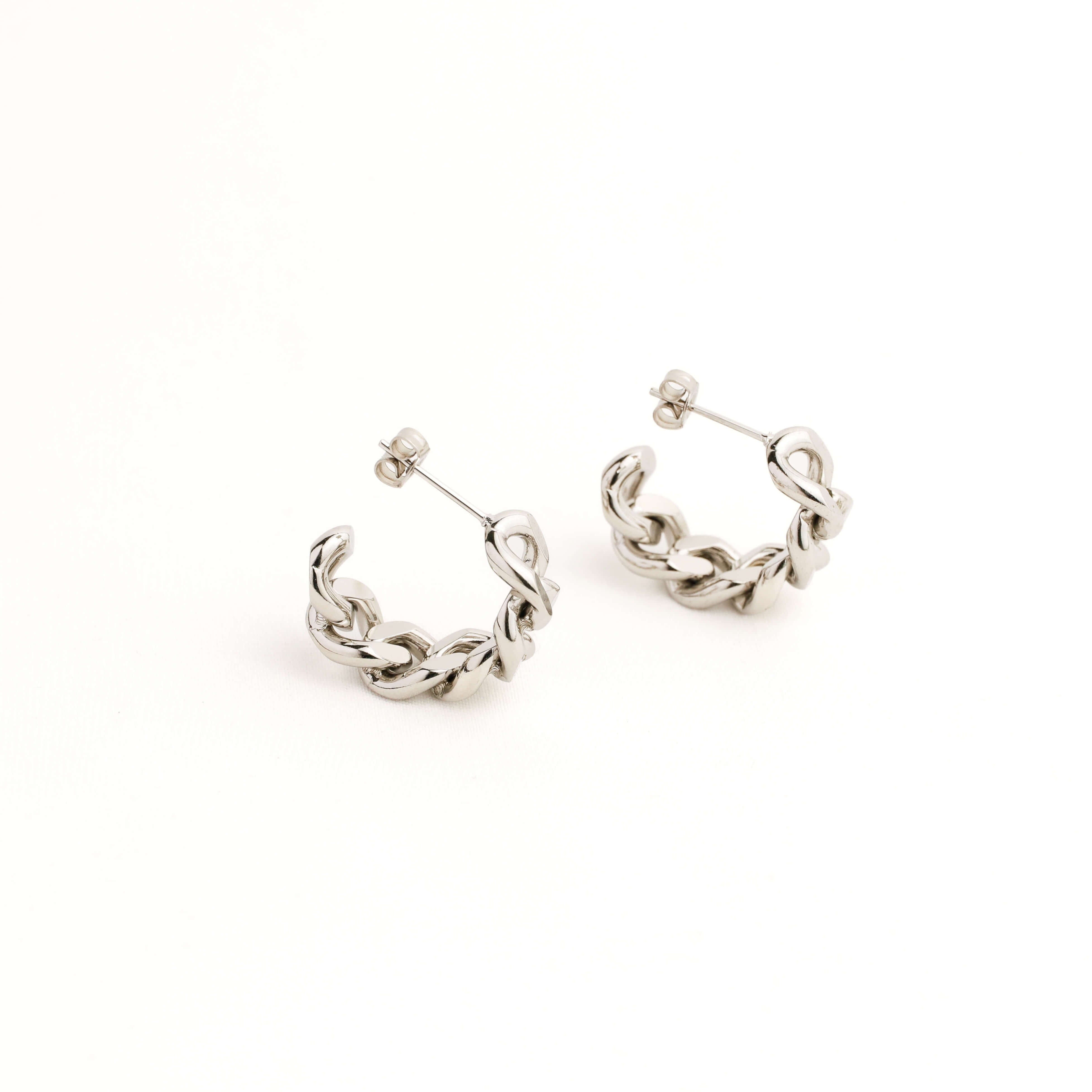 Pair of silver chain hoop earrings on a white background