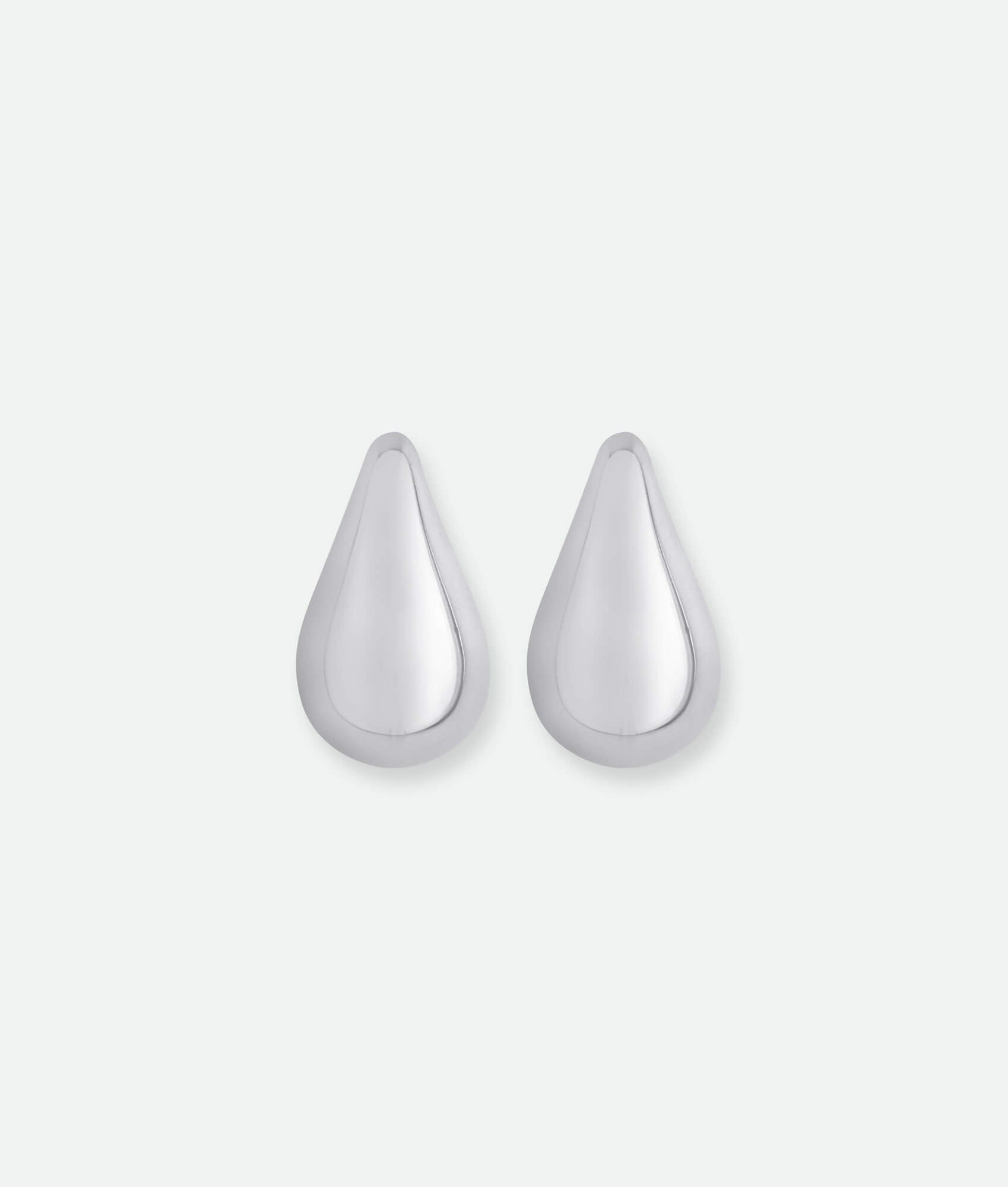 Pair of silver teardrop-shaped earrings on a white background