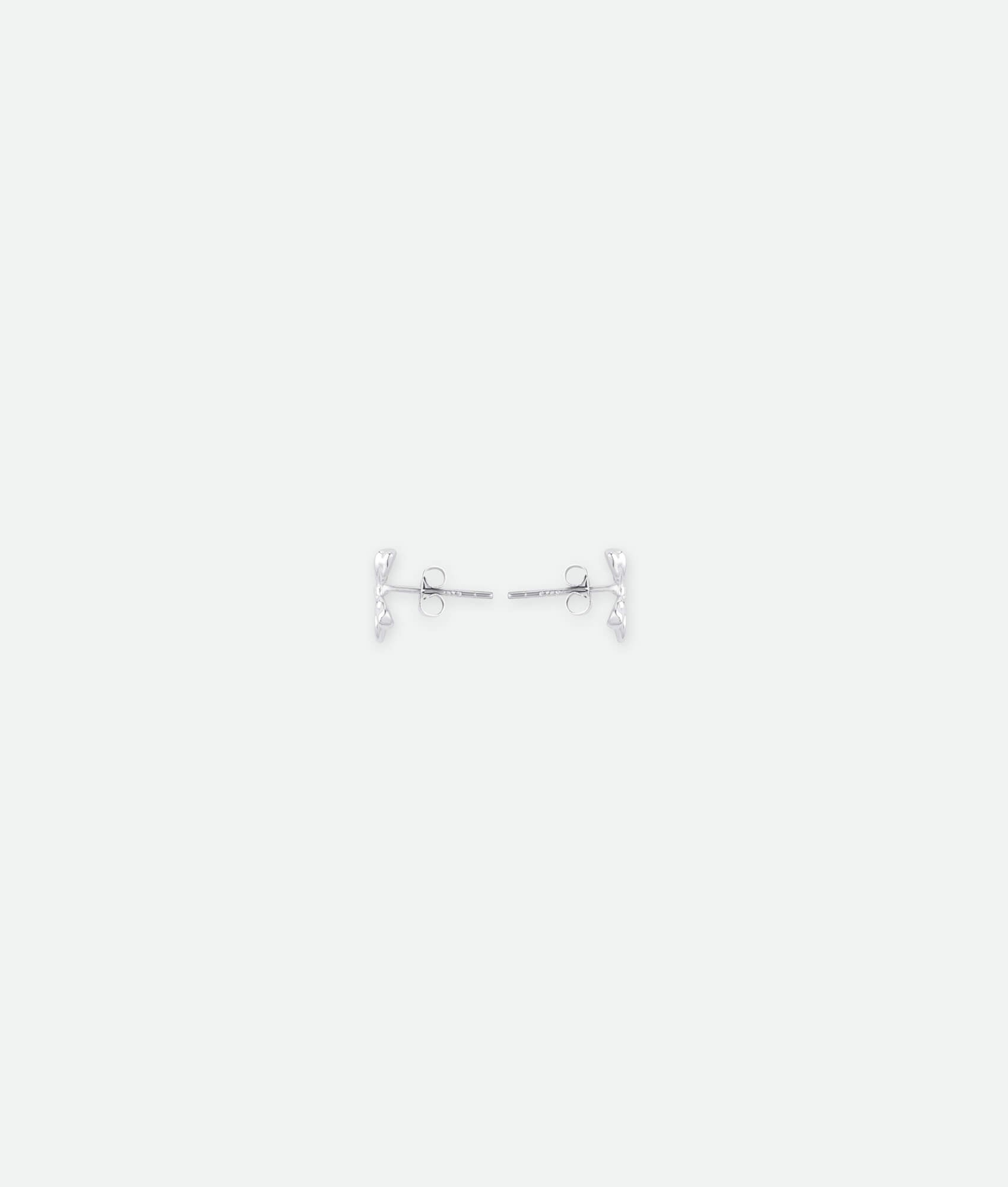 Silver barbell earring on a white background