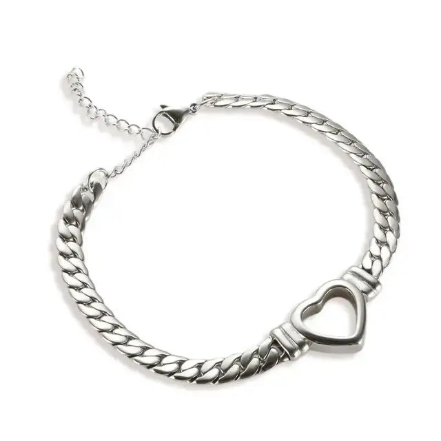 Silver chain bracelet with a heart-shaped clasp on a white background