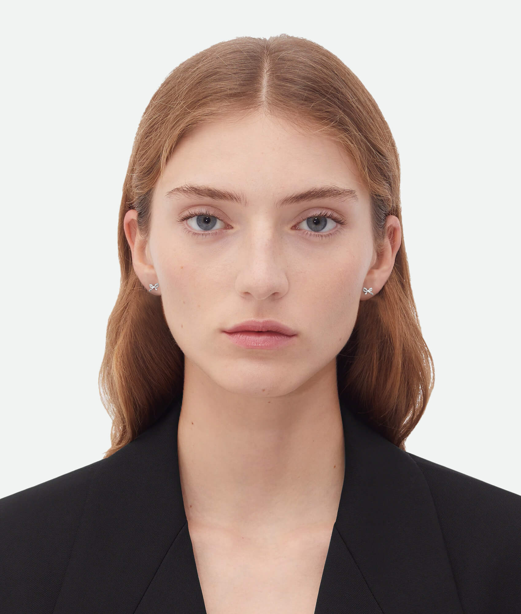 Woman wearing a black blazer against a white background