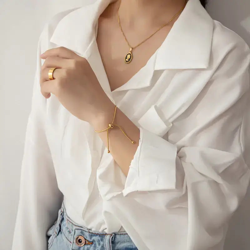 Model wearing 18k gold chain bracelet adjustable