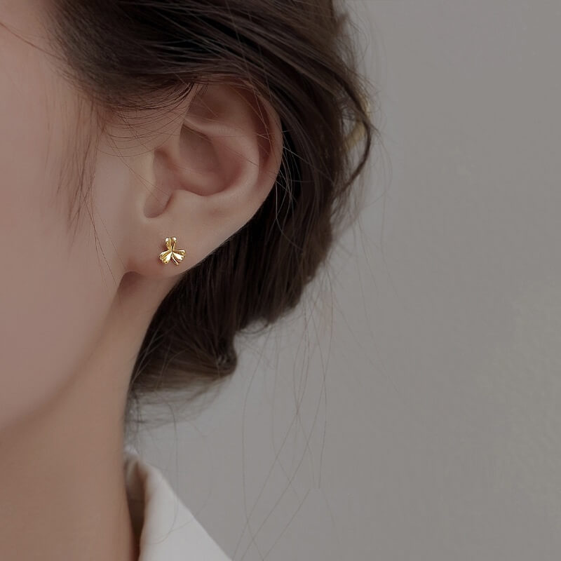 Model wearing gold Clover Leaf Stud Earrings