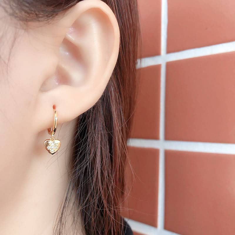 Model wearing Gold Heart Charm Earrings