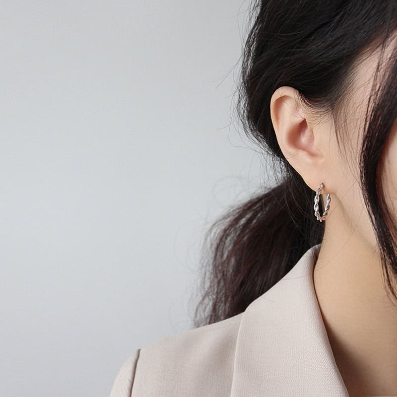 Model wearing silver Twisted Hoop Earrings