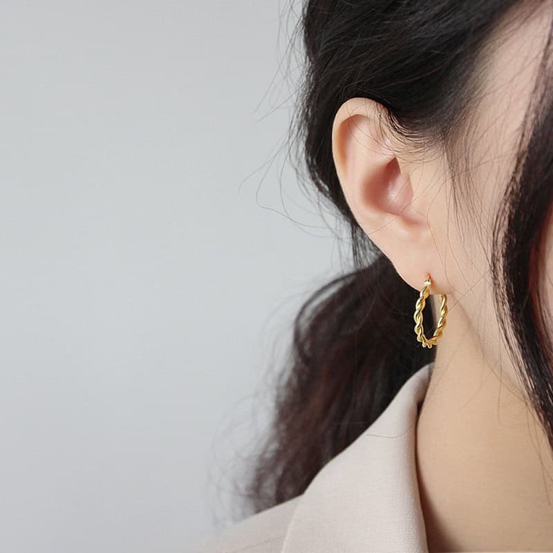 Model wearing Twisted Hoop Earrings