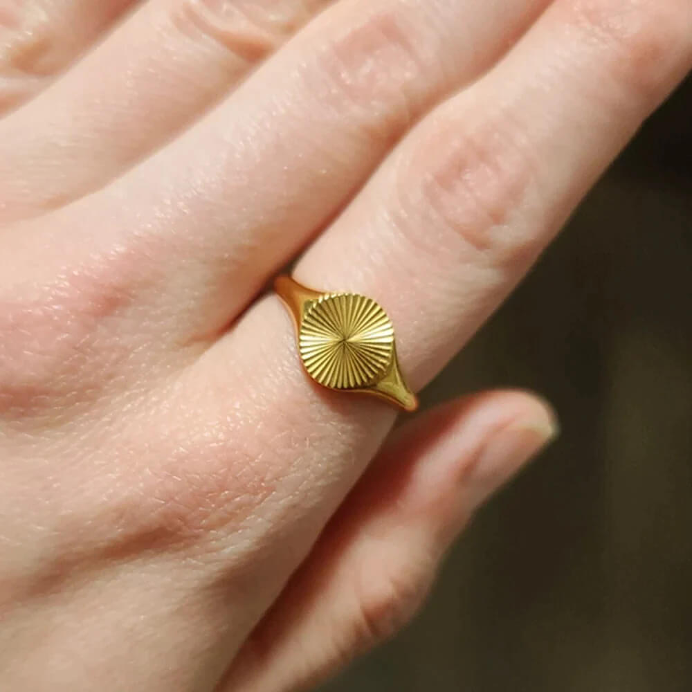 A Woman wearing Sun signet ring gold