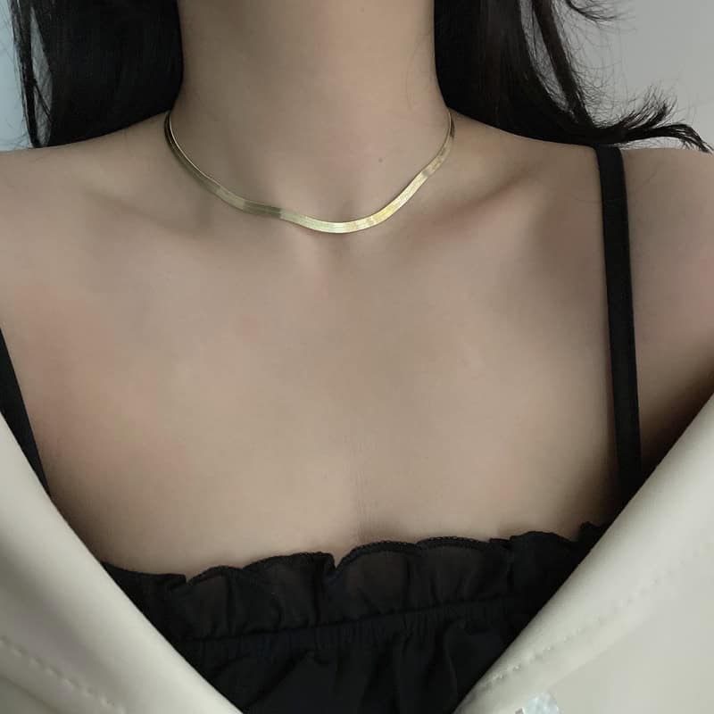 model wearing gold snake bone chain necklace