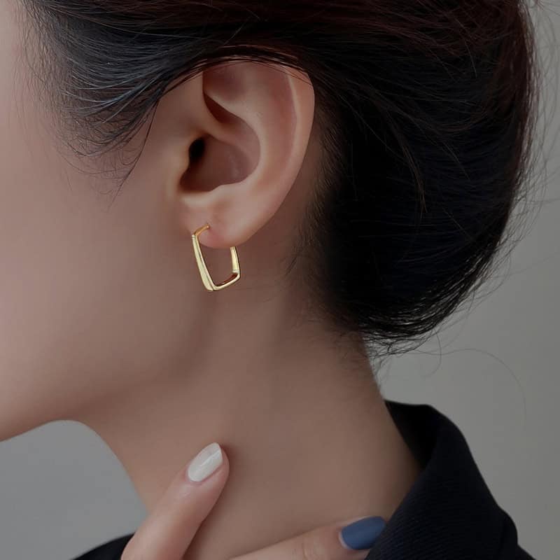 Model wearing gold Square Hoop Earrings