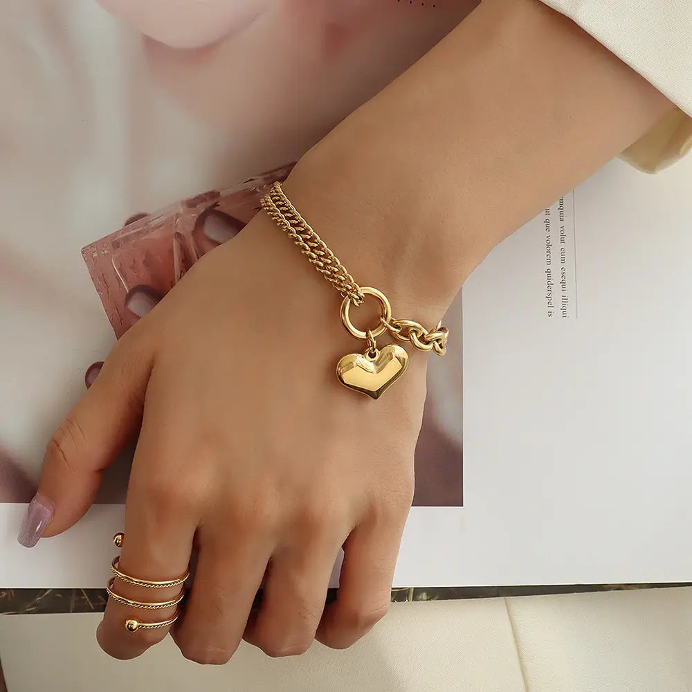 A Women wearing Gold Love Heart Bracelet