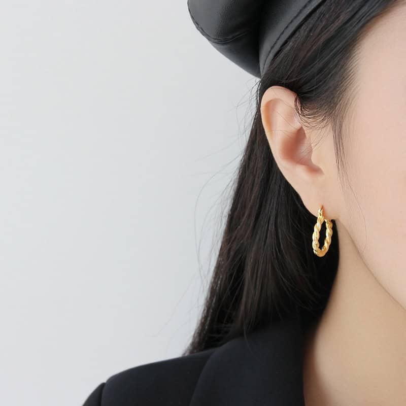 Model Wearing Twisted Gold Hoop Earrings