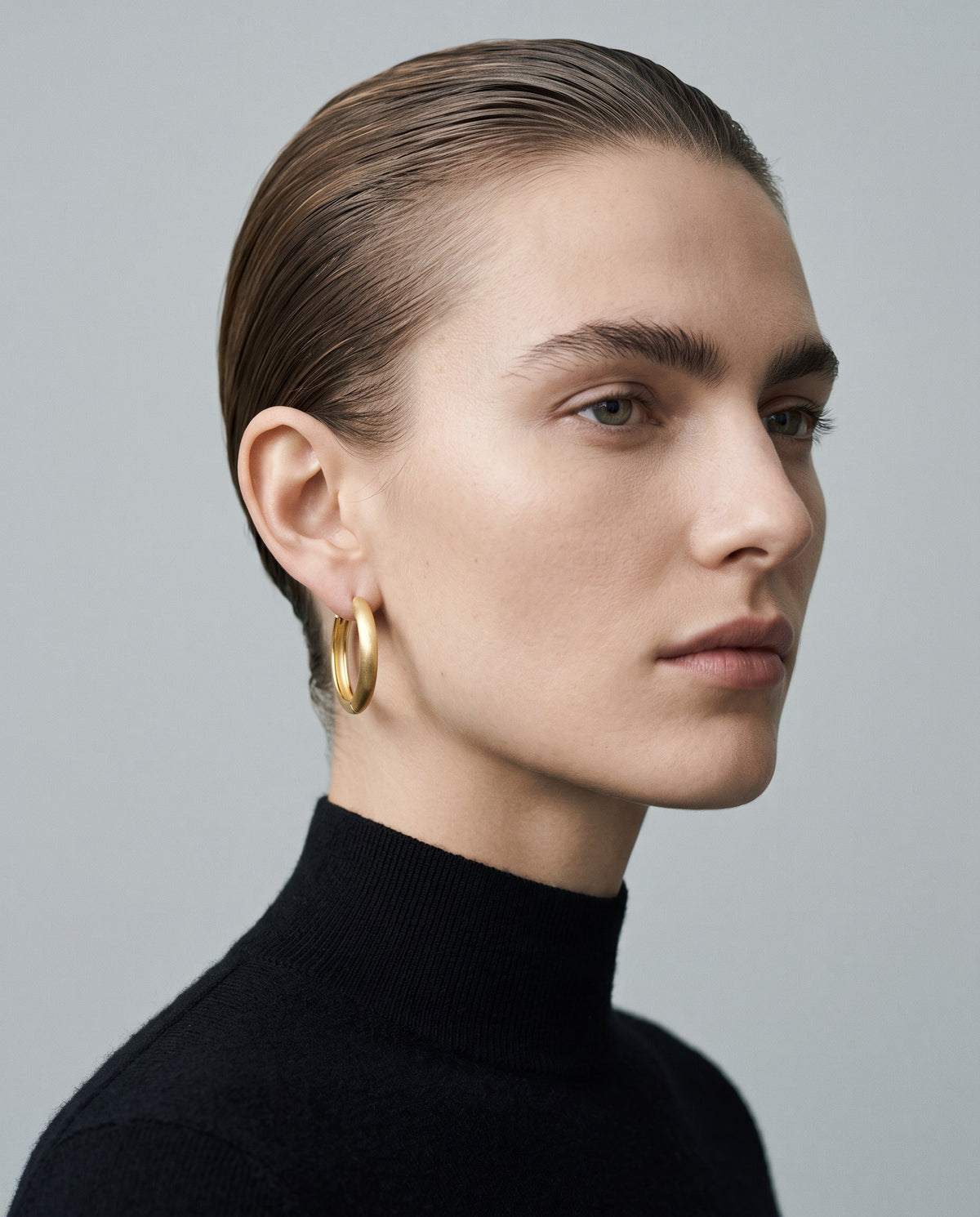 Pebble Round Huggie Earrings – editorial campaign image